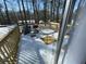 View of the exterior back deck with table and chairs covered in snow at 120 Valley Dr, Loganville, GA 30052