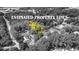 A black and white aerial view outlines property lines and its wooded lot in a neighborhood at 159 Forest Ave, Social Circle, GA 30025