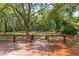 The backyard deck boasts serene views of a lush wooded lot and lots of privacy at 159 Forest Ave, Social Circle, GA 30025