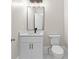 Bathroom featuring white vanity, modern mirror and fixtures, and tiled floor at 159 Forest Ave, Social Circle, GA 30025