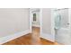 Bathroom view from an adjacent bedroom, with glass shower and white cabinets at 159 Forest Ave, Social Circle, GA 30025