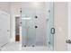 Bathroom featuring glass enclosed shower with tile surround and mosaic floor at 159 Forest Ave, Social Circle, GA 30025