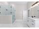 Bright bathroom featuring a glass-enclosed shower and a white vanity with modern fixtures at 159 Forest Ave, Social Circle, GA 30025