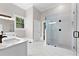 Bright bathroom featuring a glass-enclosed shower and a white vanity with modern fixtures at 159 Forest Ave, Social Circle, GA 30025