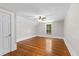 Upstairs bedroom with hardwood floors, a ceiling fan, and a window at 159 Forest Ave, Social Circle, GA 30025