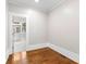 Bedroom with hardwood floors, white trim, and a view to the next room at 159 Forest Ave, Social Circle, GA 30025