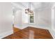 Bright dining area with modern lighting fixture and hardwood floors at 159 Forest Ave, Social Circle, GA 30025