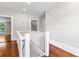 Bright hallway with hardwood floors, white walls and ceilings, and white railings at 159 Forest Ave, Social Circle, GA 30025