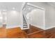 Elegant hallway with hardwood floors and staircase at 159 Forest Ave, Social Circle, GA 30025