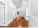 Inviting hallway with gleaming hardwood floors and fresh paint at 159 Forest Ave, Social Circle, GA 30025