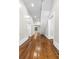 Well lit hallway featuring beautifully refinished hardwood floors at 159 Forest Ave, Social Circle, GA 30025