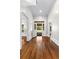 Bright, inviting hallway leads to open porch with hardwood floors at 159 Forest Ave, Social Circle, GA 30025