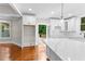 Bright kitchen with marble countertops, white cabinets, and hardwood floors at 159 Forest Ave, Social Circle, GA 30025