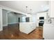 Open-concept kitchen with island, stainless appliances, and hardwood floors at 159 Forest Ave, Social Circle, GA 30025