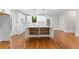 Kitchen island features open storage and hardwood floors at 159 Forest Ave, Social Circle, GA 30025
