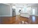 Bright, open kitchen with hardwood floors, white cabinets, stainless steel appliances and center island at 159 Forest Ave, Social Circle, GA 30025