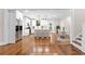 Bright, open kitchen featuring a large island with seating, stainless steel appliances, and hardwood floors at 159 Forest Ave, Social Circle, GA 30025