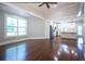 Bright living room with hardwood floors flowing into an open kitchen with stainless steel appliances at 159 Forest Ave, Social Circle, GA 30025