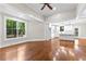 Bright living room open to the kitchen featuring hardwood floors, recessed lighting, and large windows at 159 Forest Ave, Social Circle, GA 30025