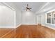 Spacious living room featuring hardwood floors, recessed lighting, a ceiling fan, and detailed trim at 159 Forest Ave, Social Circle, GA 30025