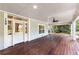 Spacious porch showcasing wood floors, ceiling fan, and bright natural light at 159 Forest Ave, Social Circle, GA 30025