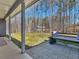 Covered patio with a view of the backyard, including a bench swing for outdoor relaxation at 1847 Davis Mill Rd, Dallas, GA 30157