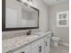Bathroom vanity boasts granite countertops, white cabinets, and sleek black hardware at 1847 Davis Mill Rd, Dallas, GA 30157