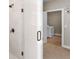 Modern shower and tub area with seamless glass entry leading to laundry room at 1847 Davis Mill Rd, Dallas, GA 30157
