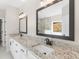 Bathroom with granite countertops, dual sinks, a large mirror, and modern fixtures at 1847 Davis Mill Rd, Dallas, GA 30157
