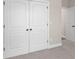 A bedroom featuring soft gray walls, plush carpeting, and a double door closet at 1847 Davis Mill Rd, Dallas, GA 30157