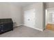 A bedroom featuring soft gray walls, plush carpeting, and a double door closet with a wooden floor at 1847 Davis Mill Rd, Dallas, GA 30157