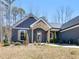 Charming home with a covered entryway, decorative shutters, and landscaped front yard at 1847 Davis Mill Rd, Dallas, GA 30157