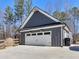 Attached garage with a large driveway and exterior lighting at 1847 Davis Mill Rd, Dallas, GA 30157