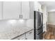 Close-up of a kitchen featuring granite countertops, white cabinets, stainless steel appliances, and tile backsplash at 1847 Davis Mill Rd, Dallas, GA 30157