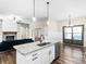Bright kitchen features an island with granite countertops, a sink, and stainless steel appliances at 1847 Davis Mill Rd, Dallas, GA 30157