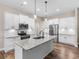 Bright kitchen with stainless steel appliances, white cabinets, granite countertops, and an island at 1847 Davis Mill Rd, Dallas, GA 30157