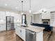 This bright kitchen features stainless steel appliances and an island with granite countertops at 1847 Davis Mill Rd, Dallas, GA 30157
