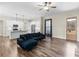 Open-concept living room with hardwood floors, white kitchen, and a comfortable dark blue sofa at 1847 Davis Mill Rd, Dallas, GA 30157