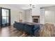 Cozy living room with a fireplace, built-in shelving, hardwood floors, and a comfortable sofa at 1847 Davis Mill Rd, Dallas, GA 30157