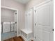 This mudroom offers coat hooks and bench seat storage adjacent to the laundry room at 1847 Davis Mill Rd, Dallas, GA 30157