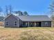 View of the rear exterior of the home, showcasing its siding and outdoor living area at 1847 Davis Mill Rd, Dallas, GA 30157