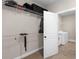 Spacious walk-in closet with shelving for optimal storage, leading to a laundry area at 1847 Davis Mill Rd, Dallas, GA 30157