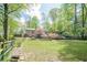 Expansive backyard featuring well-maintained lawn, mature trees, and a charming patio area at 2101 Kinridge Rd, Marietta, GA 30062
