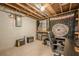 Basement workspace with exposed ductwork, carpeted floor, desk area, and storage shelves at 2101 Kinridge Rd, Marietta, GA 30062