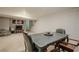 Carpeted basement featuring a drop ceiling, open concept, and seating area with a TV at 2101 Kinridge Rd, Marietta, GA 30062