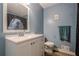 Renovated blue bathroom with white vanity, shower and modern Star Wars themed shower curtain at 2101 Kinridge Rd, Marietta, GA 30062