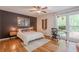 Bright bedroom featuring a ceiling fan, hardwood floors, a work station, and ample natural light at 2101 Kinridge Rd, Marietta, GA 30062