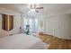 Bedroom features hardwood flooring, a ceiling fan, and a desk near the window for plenty of light at 2101 Kinridge Rd, Marietta, GA 30062
