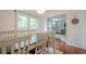 Cozy dining area with a wooden table and white chairs, offering a view into the playroom at 2101 Kinridge Rd, Marietta, GA 30062