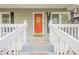 Close-up of the front porch showing the orange front door and white railings at 2101 Kinridge Rd, Marietta, GA 30062